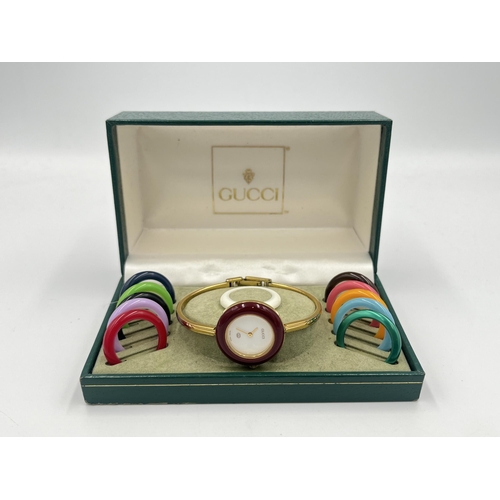 2331 - A boxed Gucci 11/12 quartz lady's wristwatch with 12 interchangeable bezels and bangle bracelet