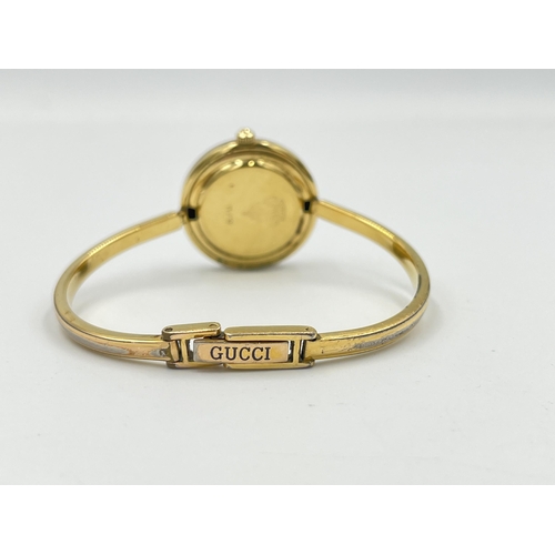 2331 - A boxed Gucci 11/12 quartz lady's wristwatch with 12 interchangeable bezels and bangle bracelet