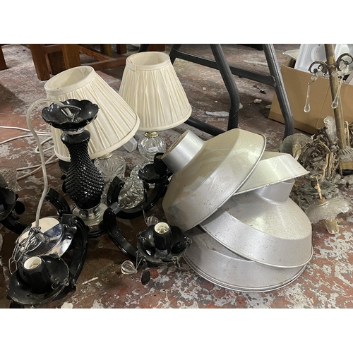 1050 - A collection of lighting items to include pendant lampshades, chandeliers etc.