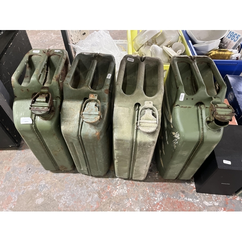 1055 - A collection of items to include four green metal jerry cans, JVC stereo system, CDs etc.