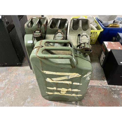 1055 - A collection of items to include four green metal jerry cans, JVC stereo system, CDs etc.