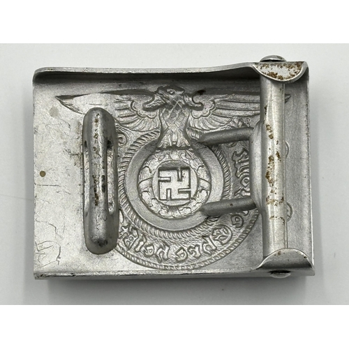 2048 - Four WWII German items, one Kriegsmarine Minesweeper badge with embossed stamp to reverse, one SS Of... 