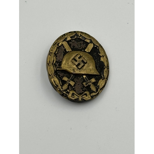 2048 - Four WWII German items, one Kriegsmarine Minesweeper badge with embossed stamp to reverse, one SS Of... 