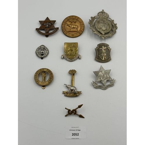 2052 - Ten military cap badges