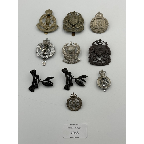 2053 - Ten military cap badges