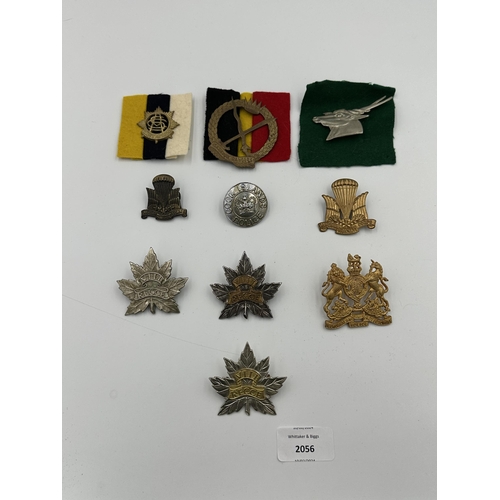 2056 - Ten military cap badges