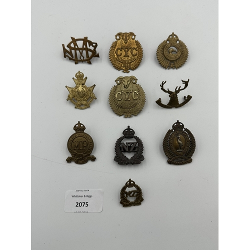 2075 - Ten military cap badges