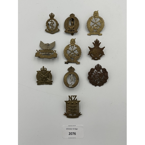 2076 - Ten military cap badges