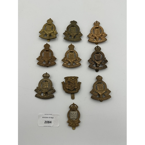 2084 - Ten military cap badges