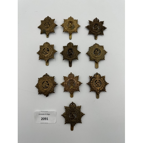 2091 - Ten military cap badges