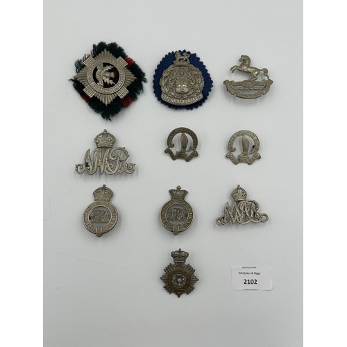 2102 - Ten military cap badges