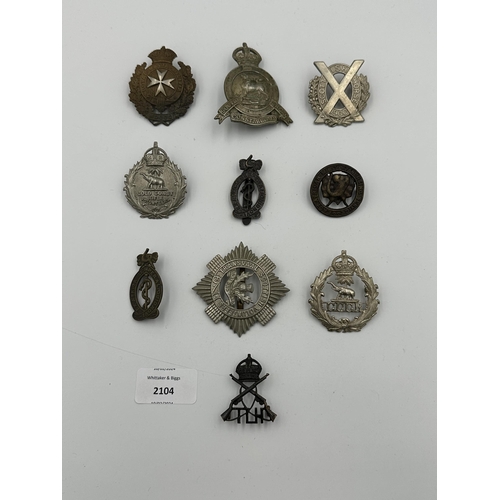 2104 - Ten military cap badges