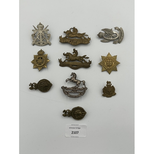 2107 - Ten military cap badges