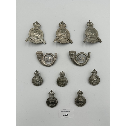 2108 - Ten military cap badges