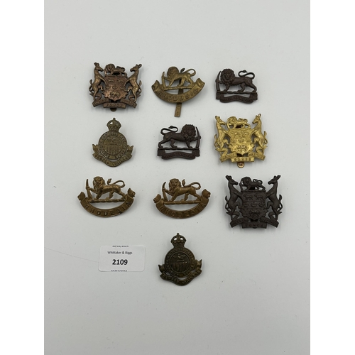 2109 - Ten military cap badges