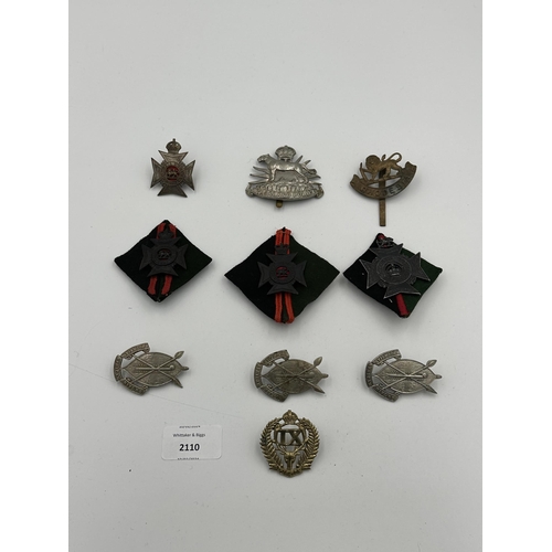 2110 - Ten military cap badges