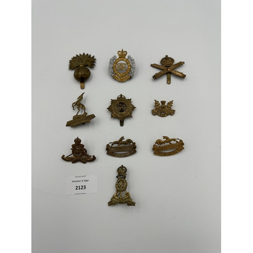 2123 - Ten military cap badges