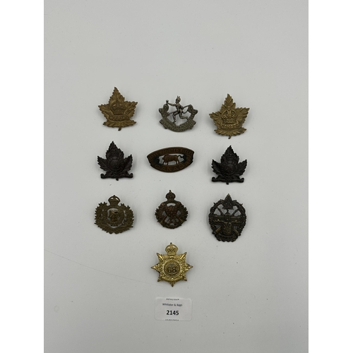 2145 - Ten military cap badges