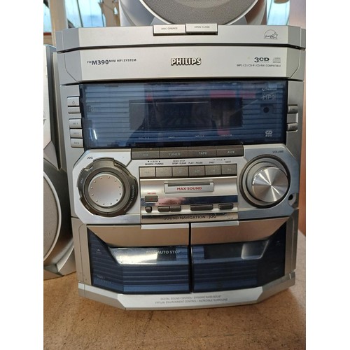 692 - A Philips FWM390 mini hi-fi system comprising three-disc-changer CD player, tuner, twin cassette dec... 