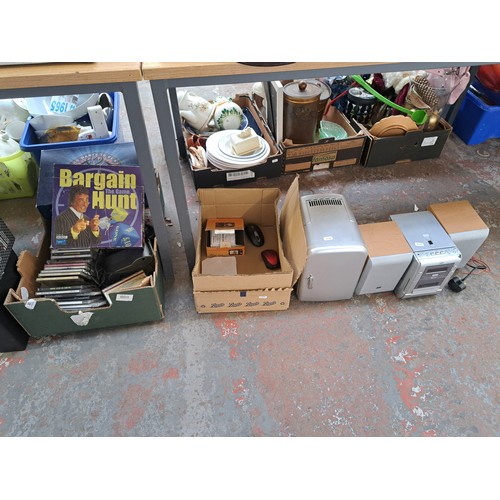 1055 - A collection of items to include four green metal jerry cans, JVC stereo system, CDs etc.