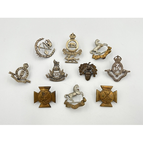 2043 - Ten military cap badges