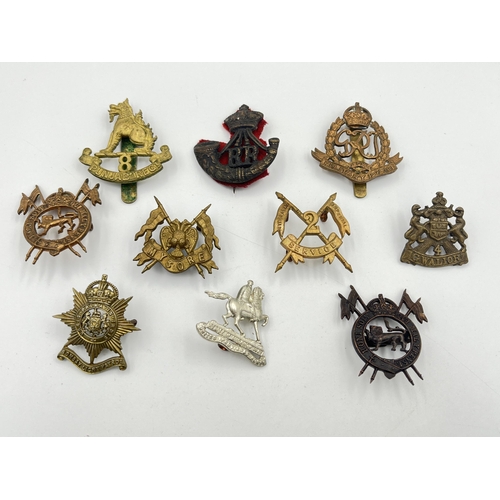 2053 - Ten military cap badges