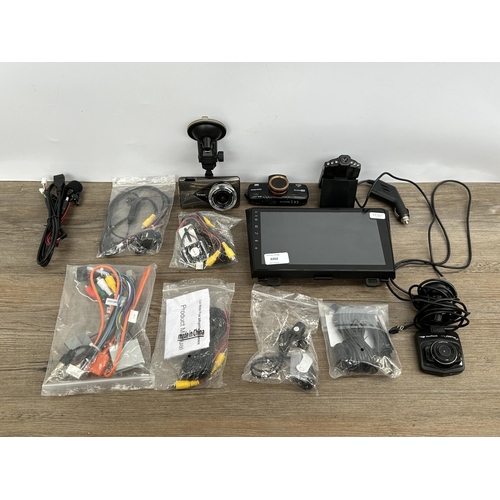 719 - Seven automotive accessories to include four dash cams, two reversing cameras and one aftermarket to... 