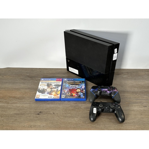 731 - A Sony PlayStation 4 CUH-1003A console with two controllers and two games