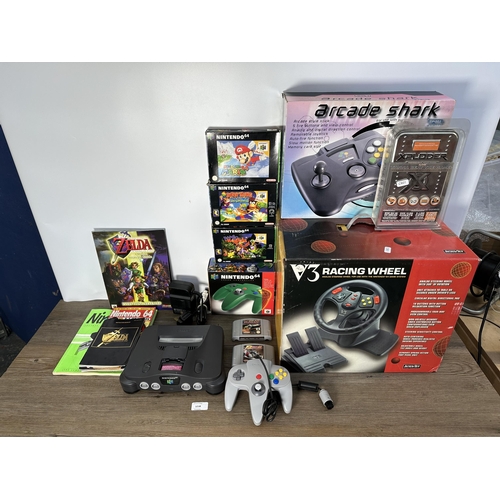 735 - A Nintendo N64 console with boxed controller, boxed Arcade Shark SV-364 fight stick, boxed racing wh... 