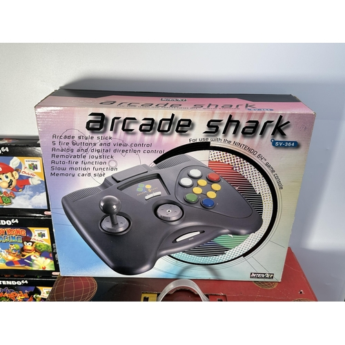 735 - A Nintendo N64 console with boxed controller, boxed Arcade Shark SV-364 fight stick, boxed racing wh... 