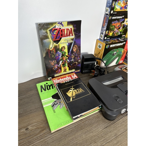 735 - A Nintendo N64 console with boxed controller, boxed Arcade Shark SV-364 fight stick, boxed racing wh... 