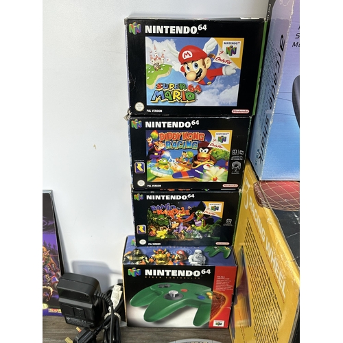 735 - A Nintendo N64 console with boxed controller, boxed Arcade Shark SV-364 fight stick, boxed racing wh... 