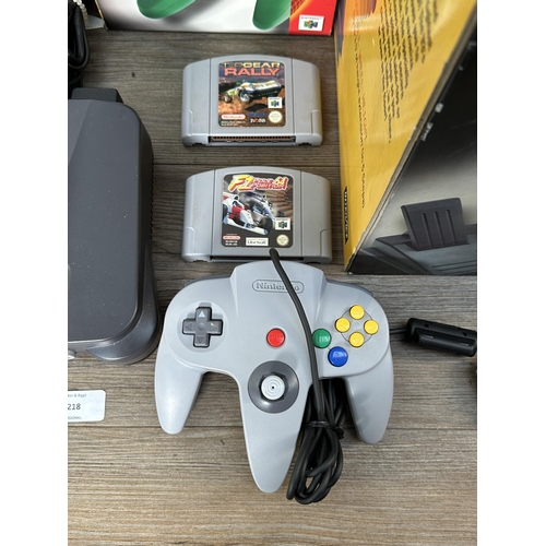 735 - A Nintendo N64 console with boxed controller, boxed Arcade Shark SV-364 fight stick, boxed racing wh... 