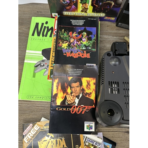 735 - A Nintendo N64 console with boxed controller, boxed Arcade Shark SV-364 fight stick, boxed racing wh... 