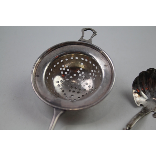 2249 - Three silver items to include sterling sugar sifter, sterling tea strainer etc. - approx. gross weig... 