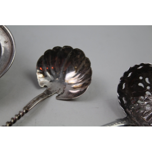 2249 - Three silver items to include sterling sugar sifter, sterling tea strainer etc. - approx. gross weig... 