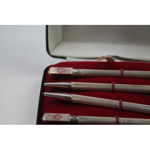 2271 - A boxed set of four stamped .925 sterling silver pencils with enamel card suit detail - approx. gros... 