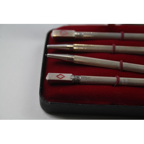 2271 - A boxed set of four stamped .925 sterling silver pencils with enamel card suit detail - approx. gros... 