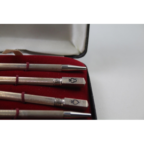 2271 - A boxed set of four stamped .925 sterling silver pencils with enamel card suit detail - approx. gros... 