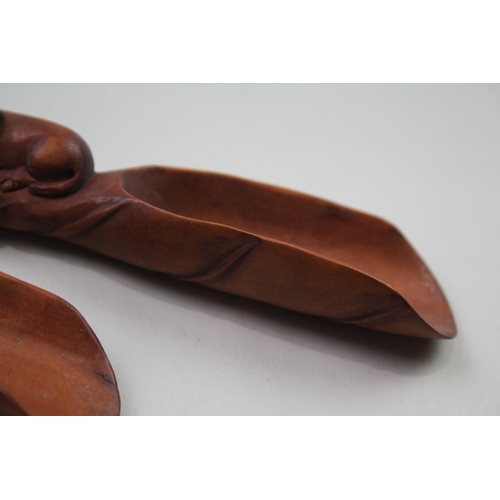 2353 - Two Oriental carved wooden zodiac snake tea/coffee scoops