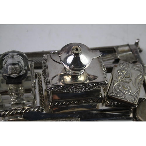 443 - A collection of antique silver plated items to include desk tidy, ink wells, letter opener etc.