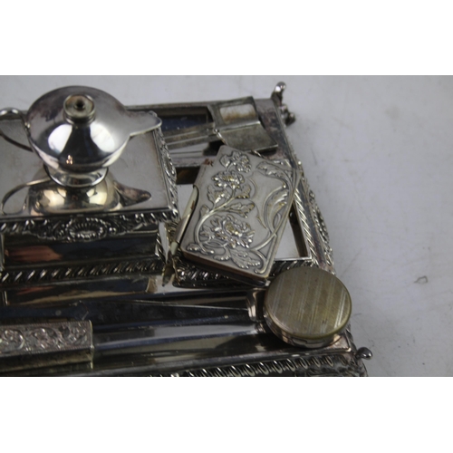 443 - A collection of antique silver plated items to include desk tidy, ink wells, letter opener etc.