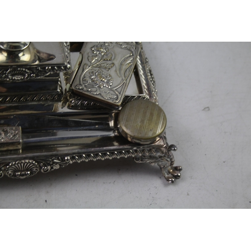 443 - A collection of antique silver plated items to include desk tidy, ink wells, letter opener etc.