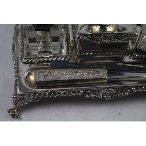 443 - A collection of antique silver plated items to include desk tidy, ink wells, letter opener etc.