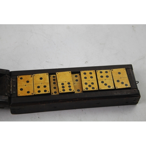 563 - A late 19th/early 20th cased dominoes set and cribbage board