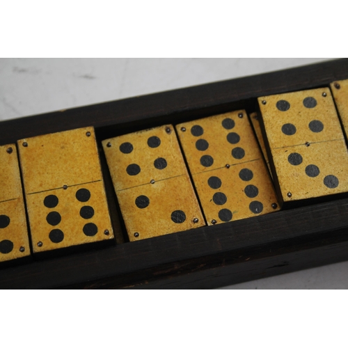 563 - A late 19th/early 20th cased dominoes set and cribbage board