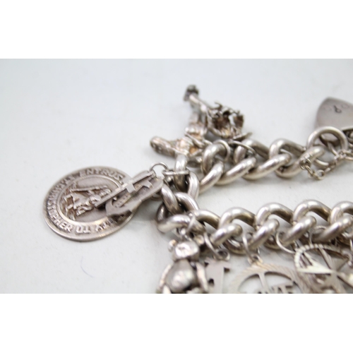 2301 - A silver charm bracelet with assorted charms - approx. gross weight 111g