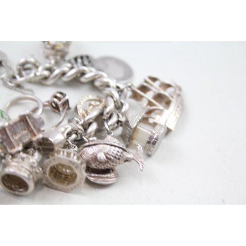 2310 - A silver charm bracelet with assorted charms - approx. gross weight 109g