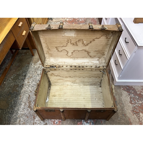 108 - An early 20th century brown fibreboard and wooden banded travel trunk