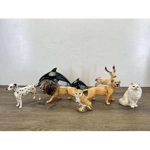 383 - Eight ceramic animal figurines, six Beswick and two Poole Pottery dolphins